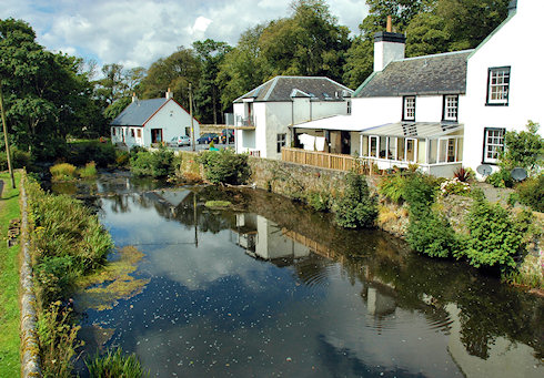 Picture of a few houses along a small river