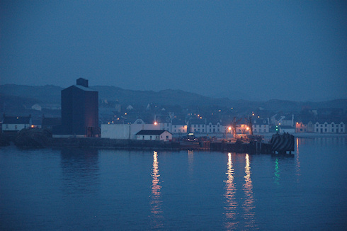 Picture of a small ferry terminal and a grain silo in the evening light