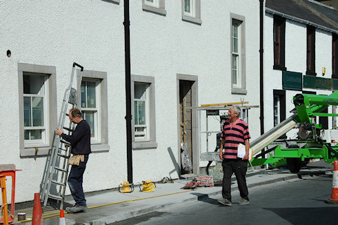 Picture of a two men in front of an under construction hotel