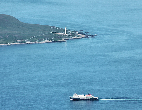 Picture of a Calmac ferry passing a lighthouse, seen from high above