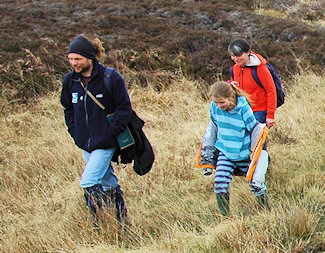 Picture of a family of three walking in the wilderness of Islay