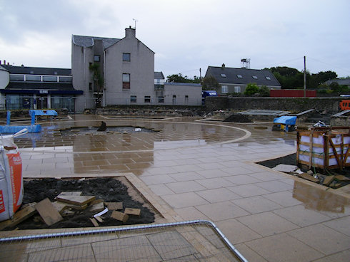 Picture of a town square under refurbishment, a look towards the back