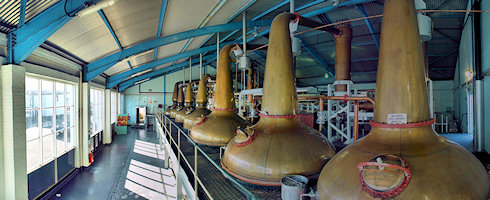 Small panoramic view of the inside of the still house of Laphroaig distillery on Islay
