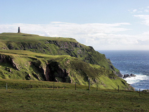 Picture of a memorial tower standing on the top of some sea cliff