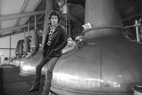 Picture of a row of stills with Bruce Springsteen standing in front of them