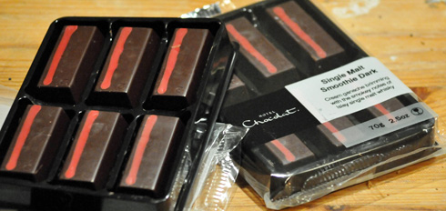 The remaining two packs after the first was eaten over the weekend. Of which one is now gone. Picture of two packs of Hotel Chocolat whisky chocolate, one opened