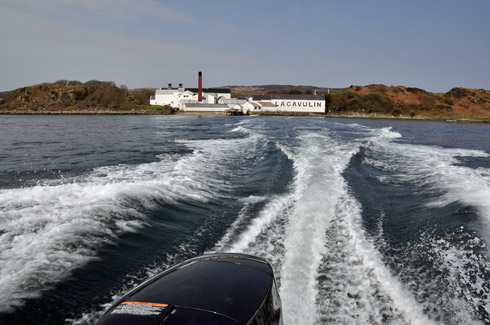 Picture of Lagavulin distillery on Islay seen from a speeding motorboat