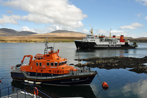 Picture of an RNLI lifeboat and a Calmac ferry in a sound