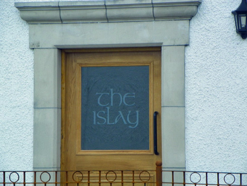 Picture of a hotel door with the name 'the islay' etched into the glass