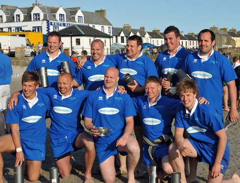 Picture of a male beach rugby team