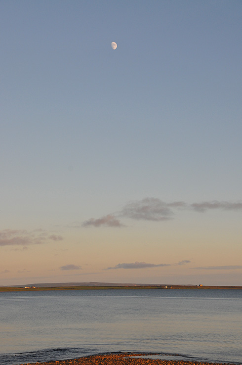 A June evening at Loch Indaal Picture of a sea loch with the Moon high above it