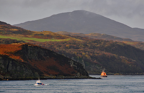 Picture of two boats in a sound, one a lifeboat, the other a fishing boat