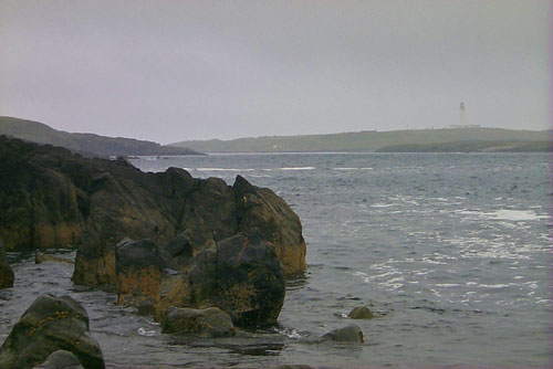 Picture of a view towards a lighthouse on a cloudy and misty day