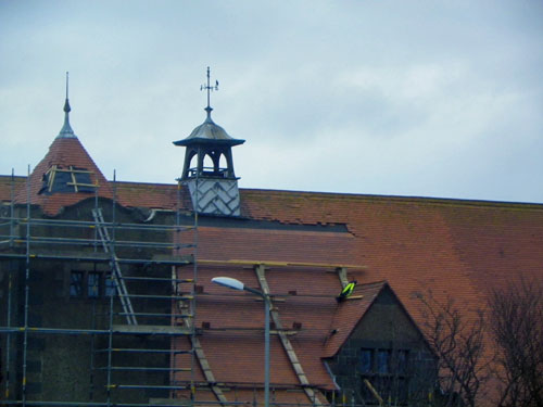 Picture of a building with roof repairs under way
