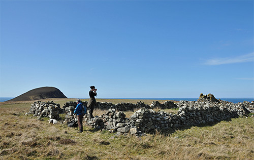 Picture of the ruin of a croft with a hill in the distance