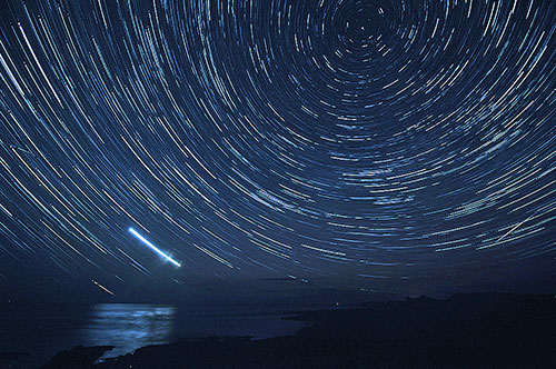 Picture of star trails over a wide bay