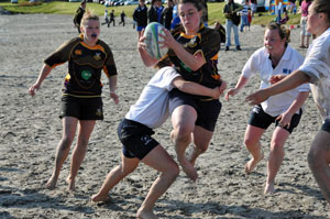 Picture of two ladies beach rugby teams in action