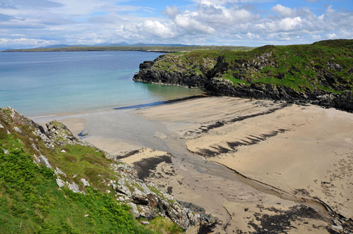 Picture of a small beach hidden between steep cliffs