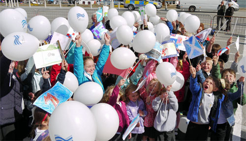 Port Ellen Primary cheering at the opening Picture of a group of children with balloons and flags