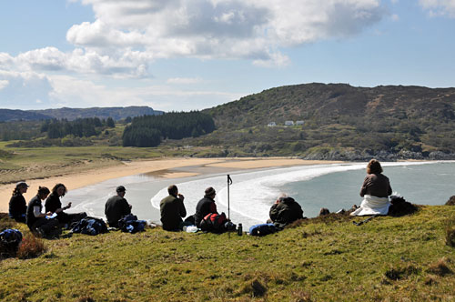 Picture of walkers taking a break with a view of a sandy bay