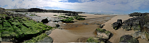 Panoramic picture of a river crossing a beach