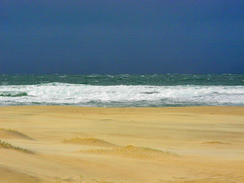 Picture of very dark clouds moving in over a beach