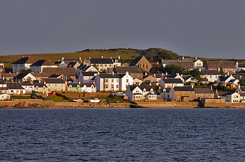 Picture of a view over a sea loch to a village with a guesthouse