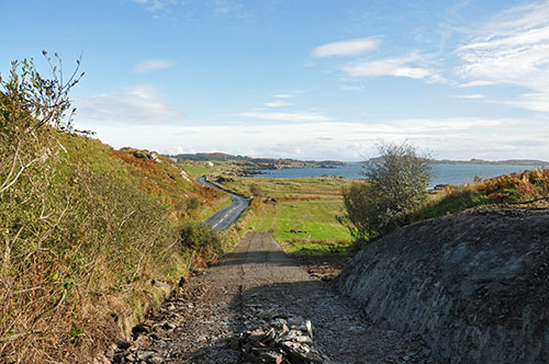 Picture of a view from a coastal path towards a distillery