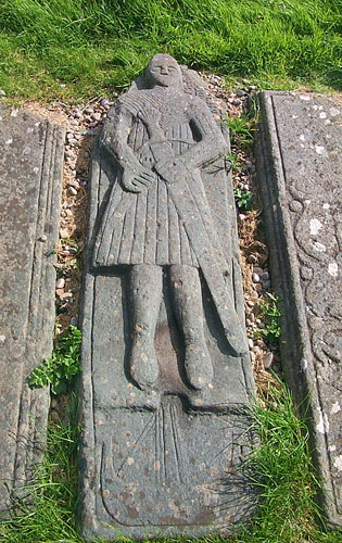 Picture of an ancient graveslab of a man in Highland armour