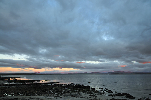 Picture of dramatic colourful clouds over a sea loch