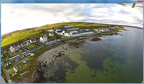 Screenshot from a video showing an aerial view of a coastal village