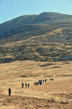 Picture of a group of walkers approaching a mountain