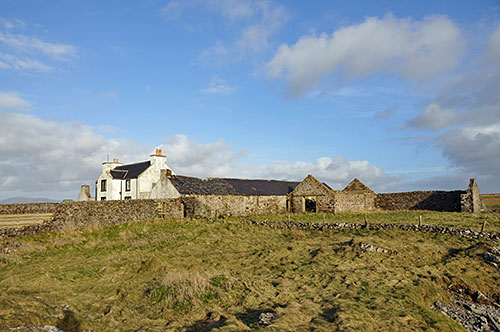Picture of an old farm with several ruined buildings
