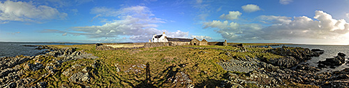 Panoramic picture of a farm with outbuildings mostly in ruins
