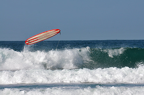 Picture of a surfboard thrown into the air after the surfer fell off