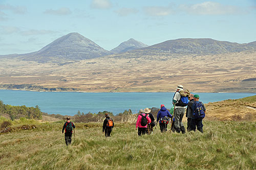 Picture of a group of walkers above a Sound between two islands