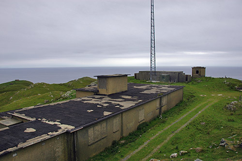 Picture of some old buildings on the top of a hill overlooking the sea
