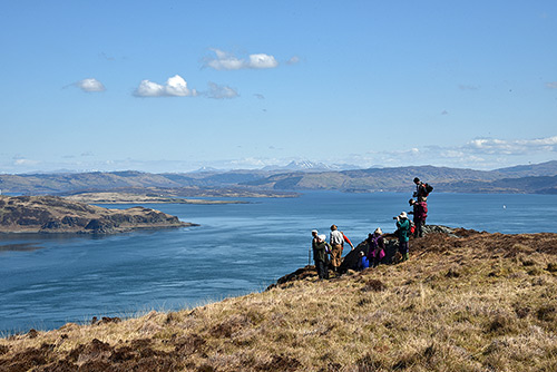 Picture of a group of walkers high above a gulf between two islands