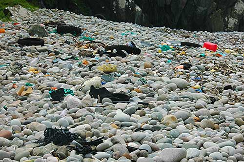 Picture of various rubbish on a pebble beach