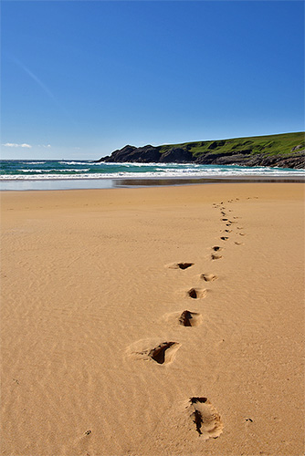 Picture of footsteps in the sand on a beach